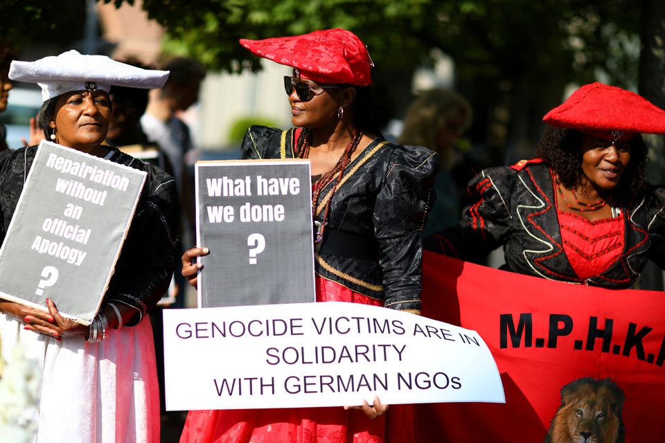 People protest outside a ceremony in Berlin, Germany, August 29, 2018, to hand back human remains from Germany to Namibia following the 1904-1908 genocide against the Herero and Nama. PHOTO CREDITS: REUTERS/Christian Mang.