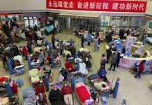 EXPLAINER: Is China sharing enough COVID-19 information? People look after their elderly relatives lying on stretchers and receiving intravenous drips while using ventilators at the Changhai Hospital hall in Shanghai, China, Tuesday, Jan. 3, 2023. As COVID-19 rips through China, other countries and the World Health Organization are calling on its government to share more comprehensive data on the outbreak. Some even say many of the reported numbers are meaningless. (Chinatopix Via AP)