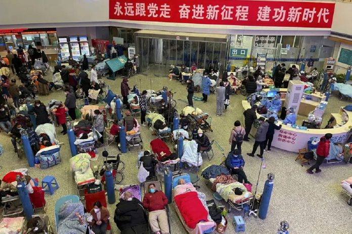 shangai hospital china People look after their elderly relatives lying on stretchers and receiving intravenous drips while using ventilators at the Changhai Hospital hall in Shanghai, China, Tuesday, Jan. 3, 2023. As COVID-19 rips through China, other countries and the World Health Organization are calling on its government to share more comprehensive data on the outbreak. Some even say many of the reported numbers are meaningless. (Chinatopix Via AP)